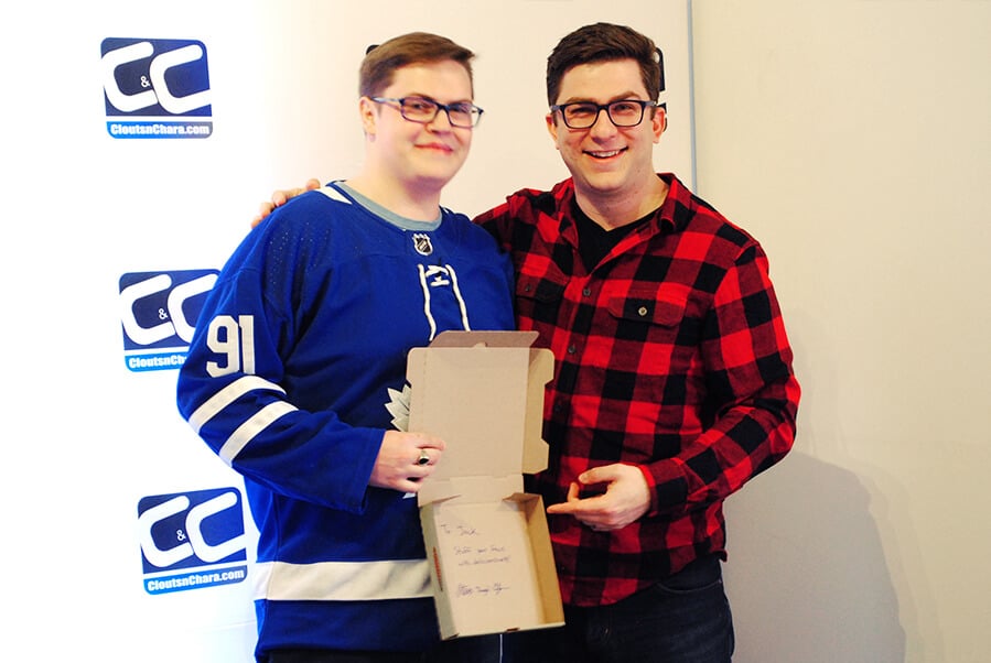 Steve Dangle Glynn and a young male teen posing for a photo while holding a signed pizza box.